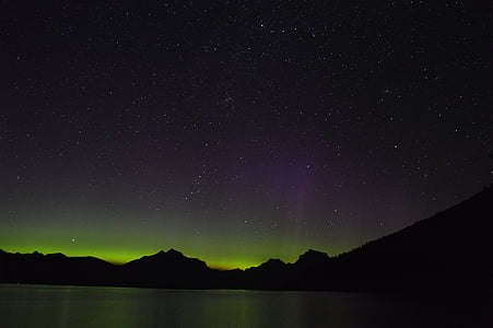 silhouette photography of mountains and aurora lights