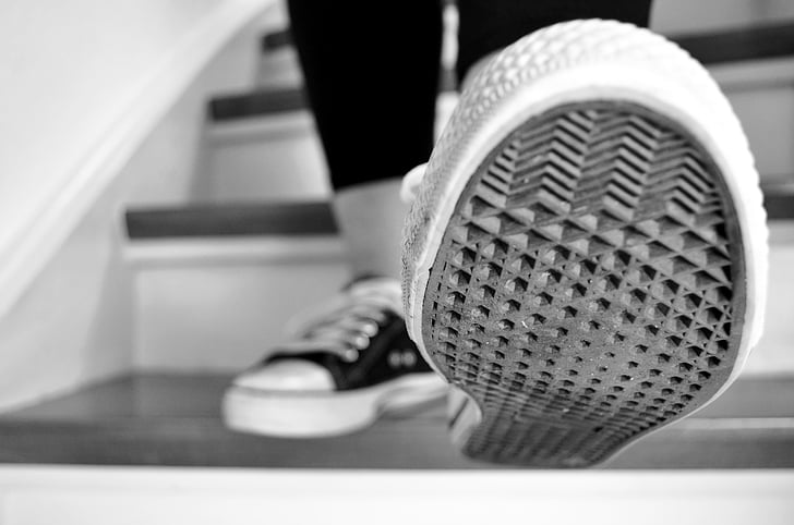 grayscale selective focus photography of shoe sole