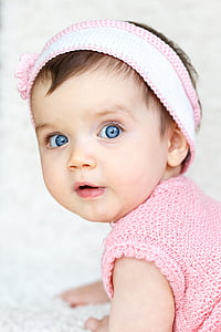 baby wearing pink knit shirt and white and pink headband