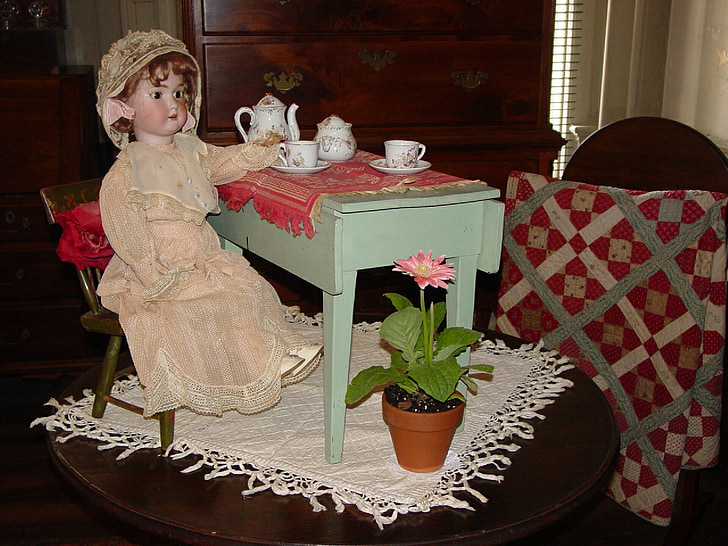 girl doll on brown wooden table
