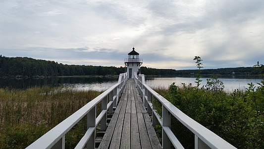 lighthouse near body of water during daytime