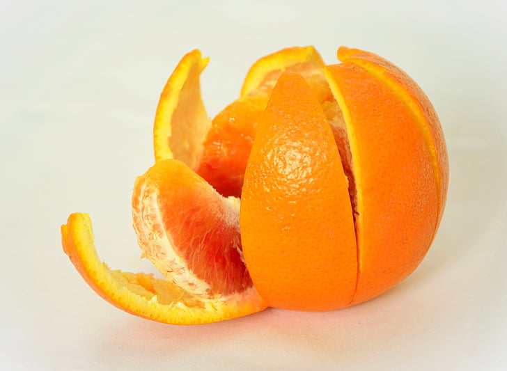 sliced orange on top of white surface