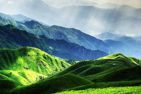 green mountains with crespular sunrays