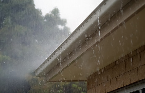 rainwater dripping on house roofs