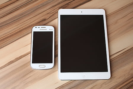 white Samsung Galaxy smartphones beside white iPad