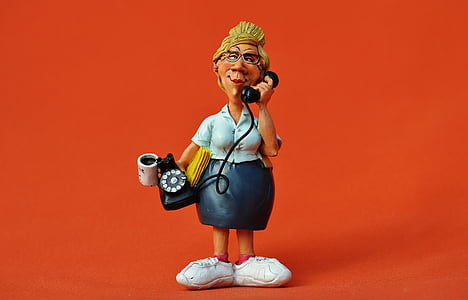 woman holding rotary telephone figurine