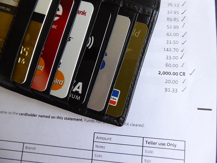 black leather card holder showing assorted cards on receipt paper