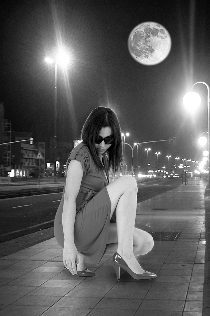 grayscale photography of woman wearing dress near street