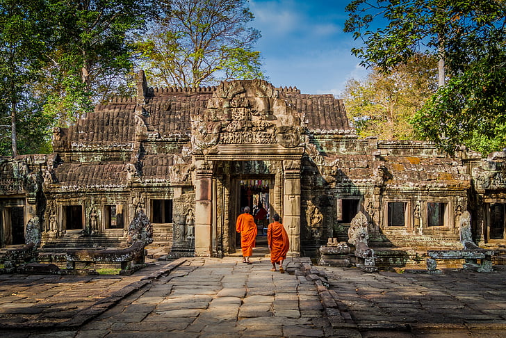 monks walking through the temple during daytime