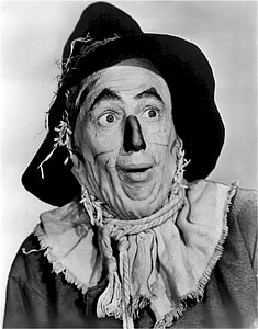 man wearing clown costume grayscale photo