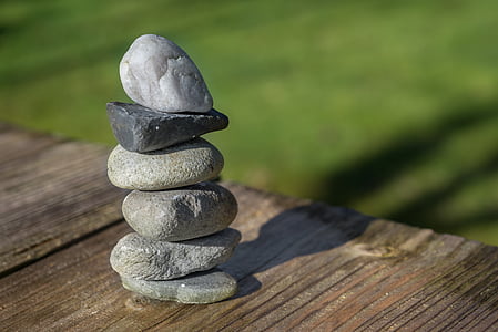 selective focus photography of cairn stone