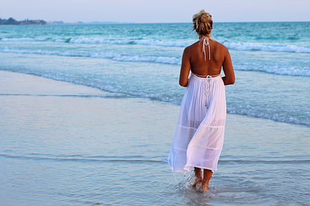 woman in white halter dress on seashore