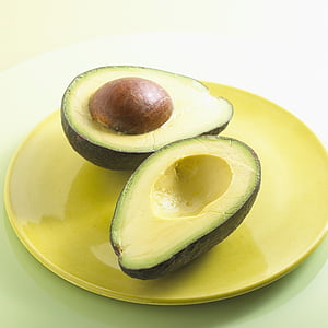 slice avocado fruit on round yellow plate