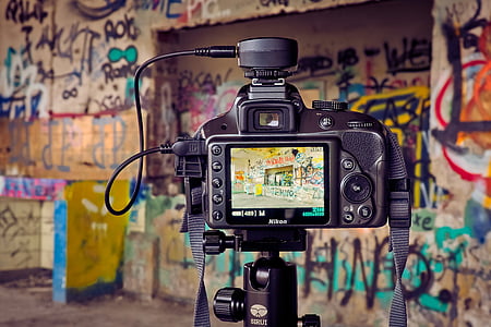 Nikon camera focusing at graffiti covered wall