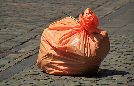 photo of orange plastic garbage bag