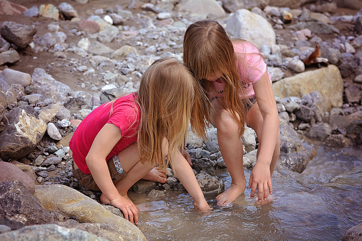 two girls playing on water
