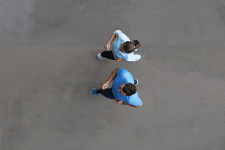 two woman and man in blue shirts running photo