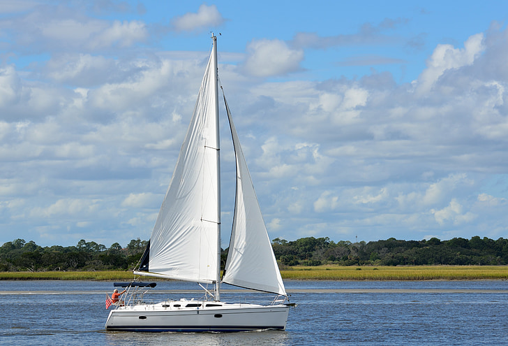 boat sailing on body of water during daytime