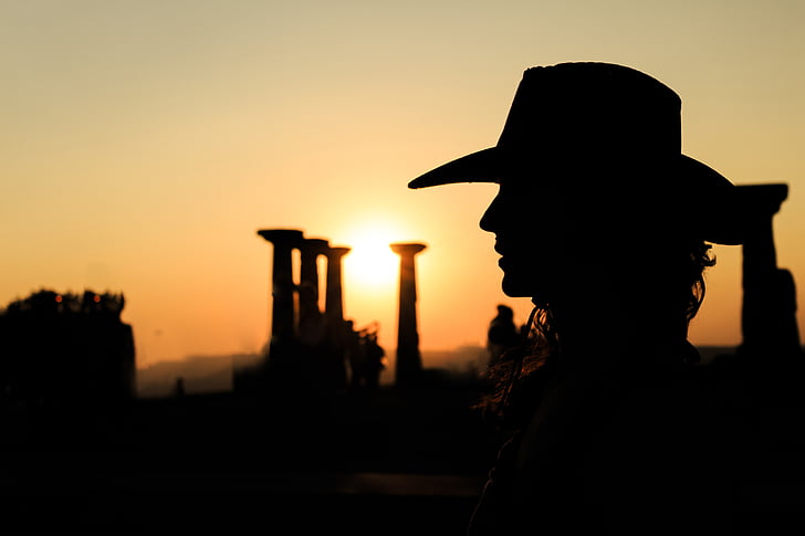 silhouette photography of person wearing cowboy hat