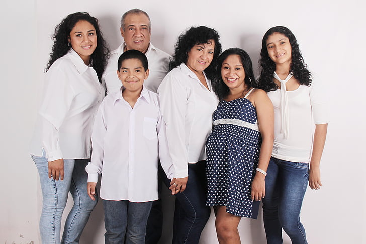 group of people smiling for a photo against white background