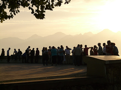 group of people standing in front of the mountain during daytime