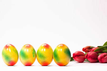 four yellow-red-and-green eggs