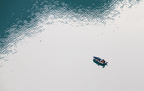 aerial photo of persons on rowboat during daytime