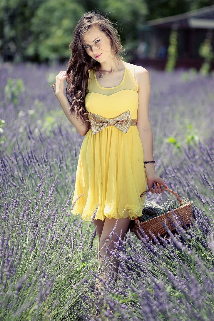 woman wearing yellow sleeveless dress on lavender field