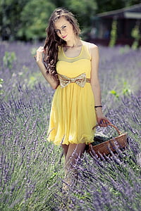 woman wearing yellow sleeveless dress on lavender field