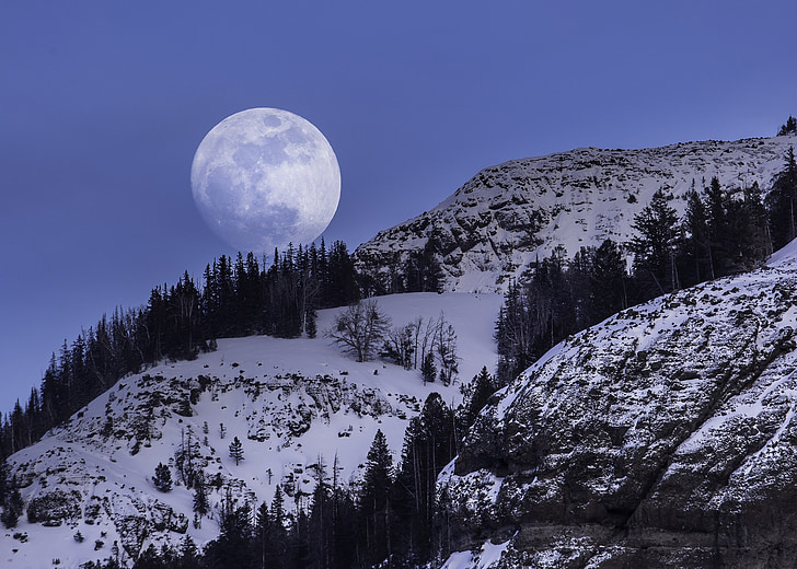 landscape photography of snow covered mountain with moon as background