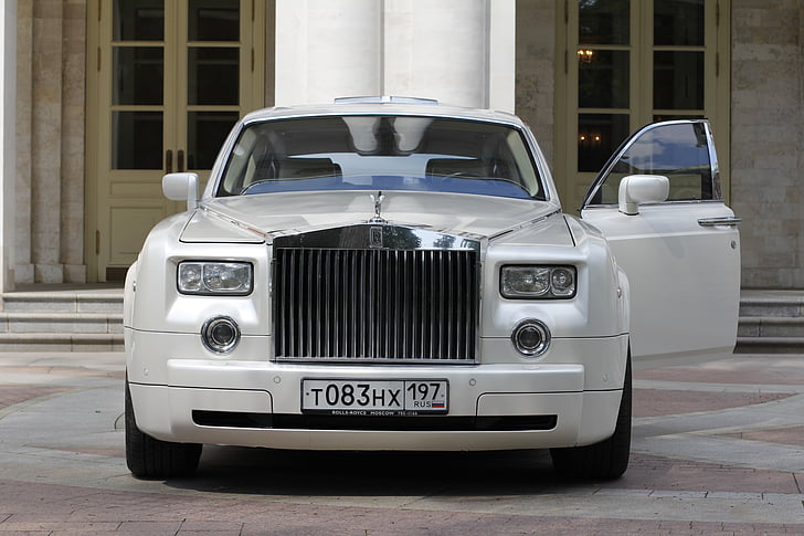 white Rolls Royce Phantom parked near mansion