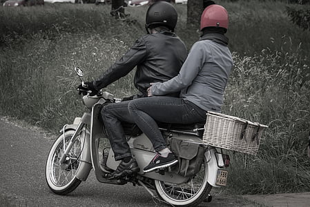 two people riding on motorcycle