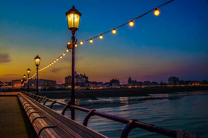 photo of outdoor lanterns beside sea