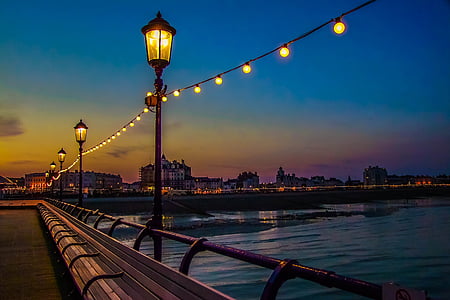 photo of outdoor lanterns beside sea