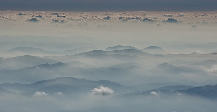 aerial photography of mountain range with fogs