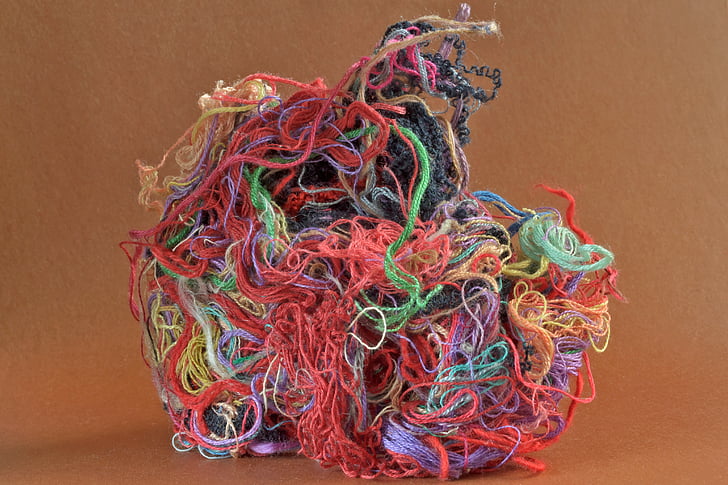 assorted-color threads on brown surface