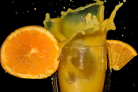orange juice on clear drinking glass
