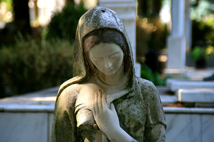 woman wearing dress with hood statue