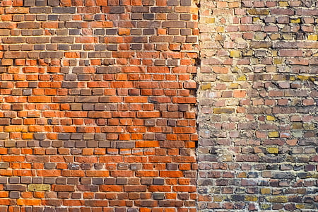 cleaned orange brick wall on the left side and dirt brown brick wall on right side