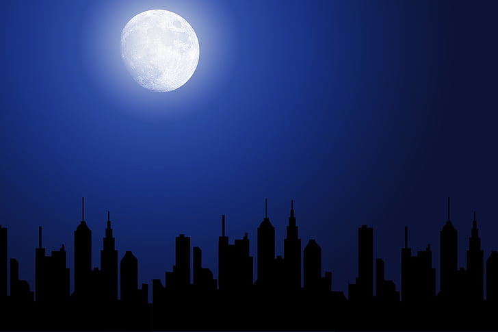 moon shining over city buildings