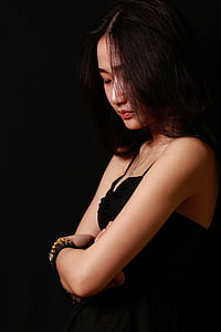 brown haired woman wearing black spaghetti strap top