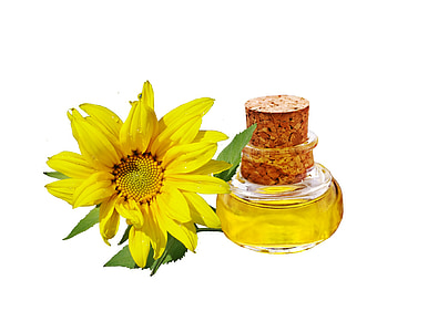 yellow petaled flower beside clear glass bottle