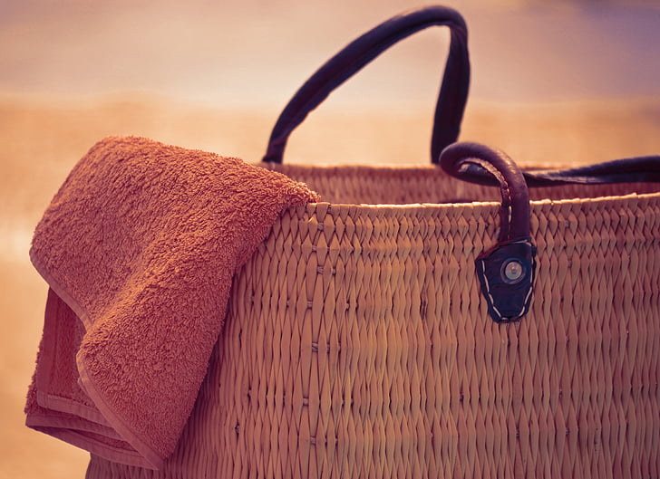 macro shot of brown towel on brown wicker bag