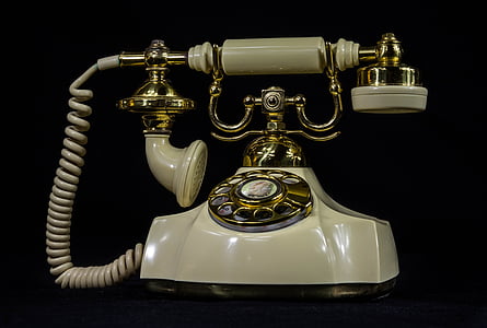 photo of white and brass rotary phone