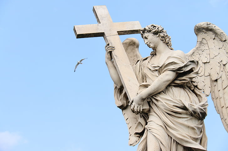 woman angel holding cross statue