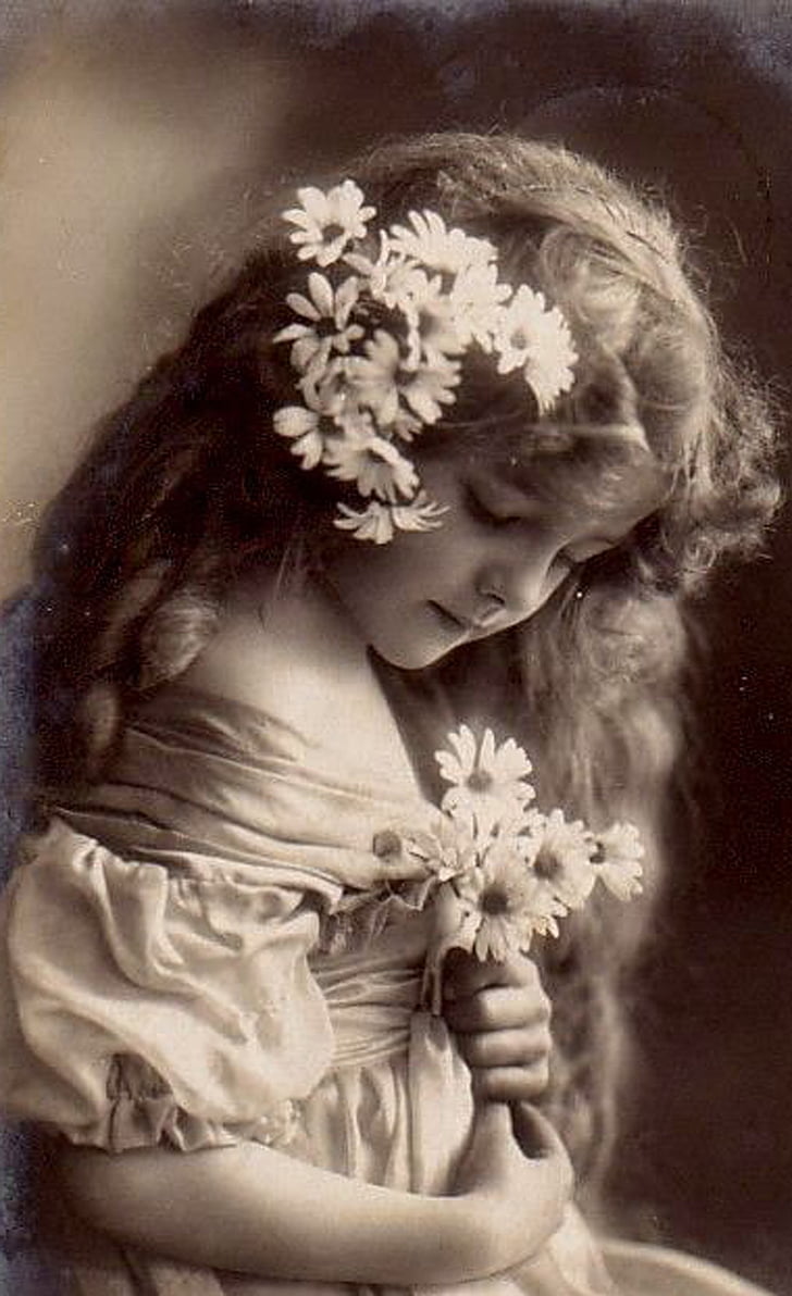 grayscale photography of girl holding flowers