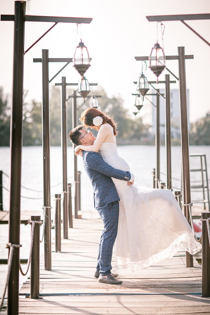 wedding couple standing on dock