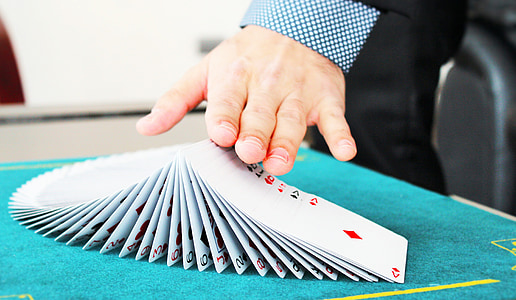 person hands on top of playing cards