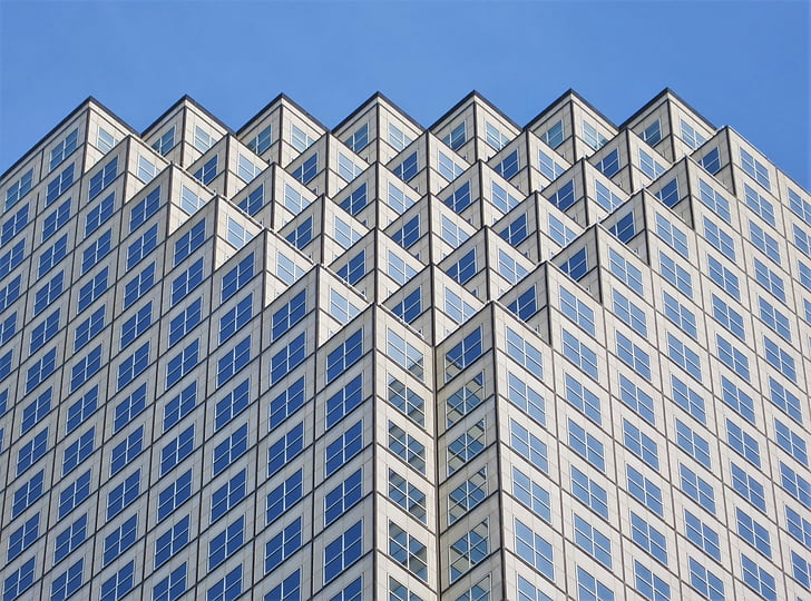 white and blue geometric high-rise building at daytime