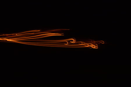time-lapse photography of orange light with black background